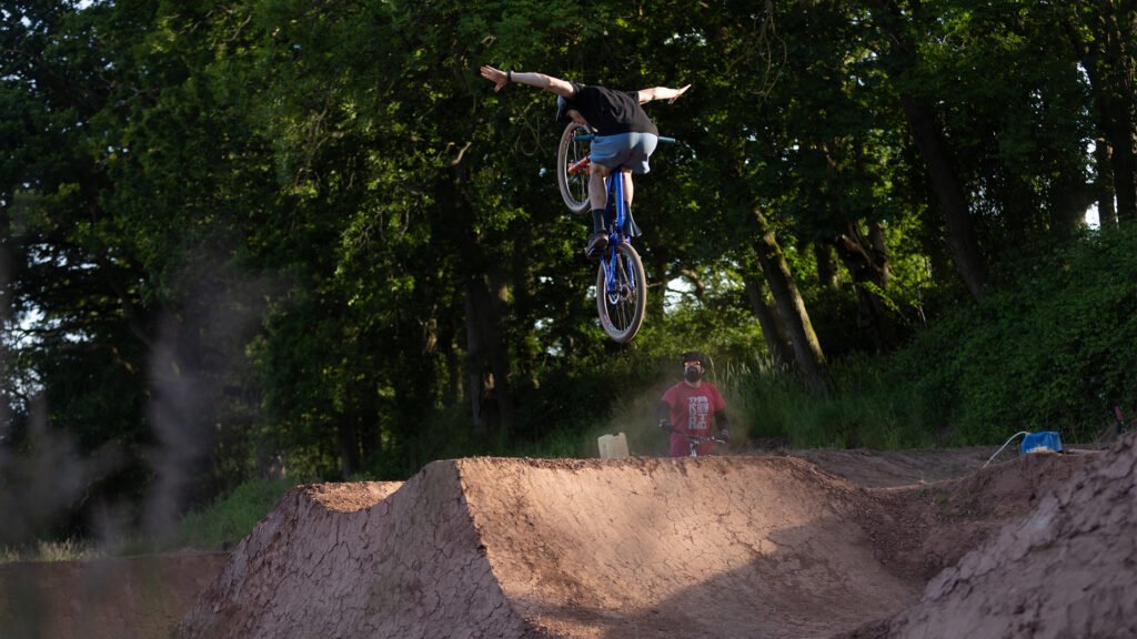 Dirt jumper in the air completing a no hander